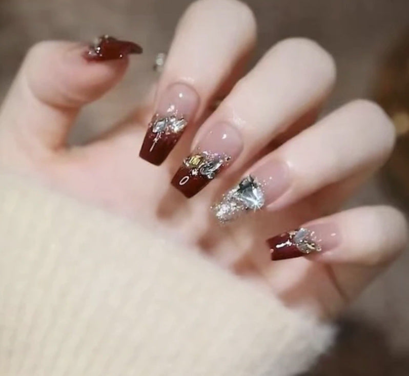 Artistic Nail Art with Glitter and Flower Applications Stornfield