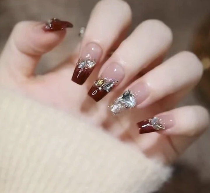 Artistic Nail Art with Glitter and Flower Applications Stornfield