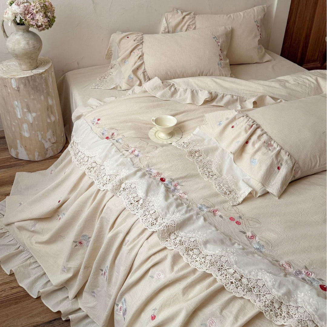 Country house style complete bedding set with voluminous bed skirt, lace trim, and fine floral embroidery