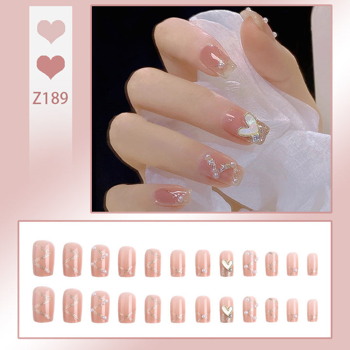 Nail art set with elegant wave patterns and delicate pearl accents Stornfield