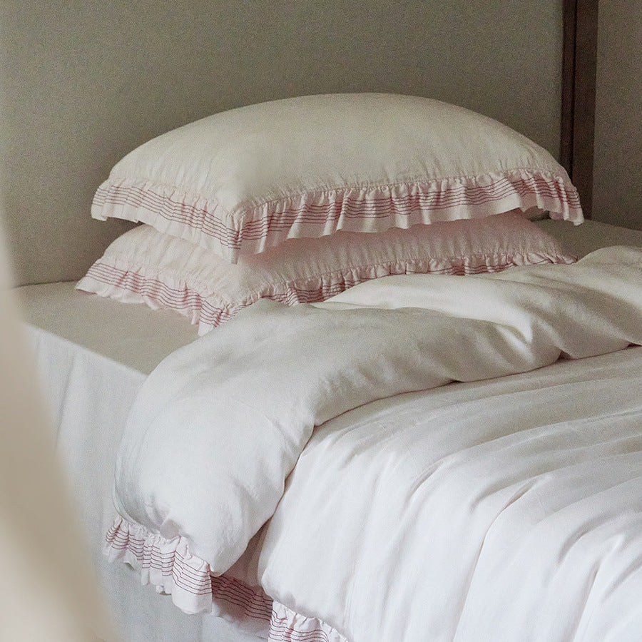 Cotton muslin duvet cover and pillowcase set with ruffle trim and finely striped piping