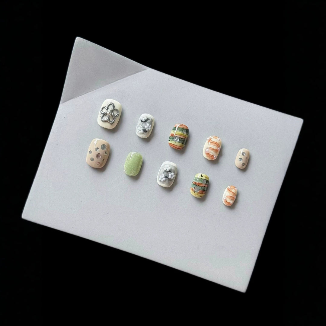 Artistic Press-On Nail Set with Floral and Textured Designs