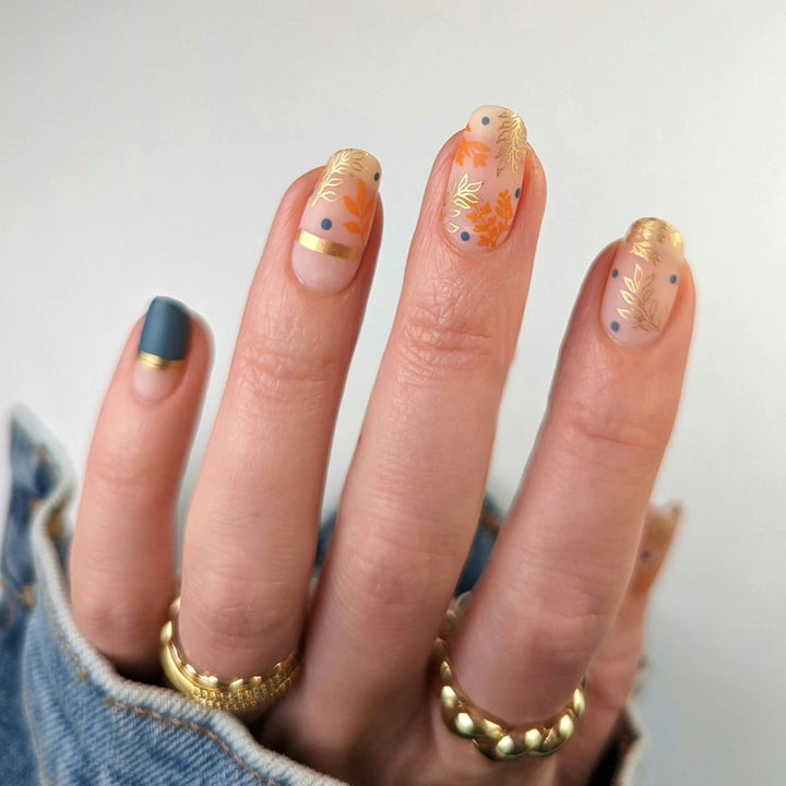 Artistic nail design with floral and golden accent Stornfield
