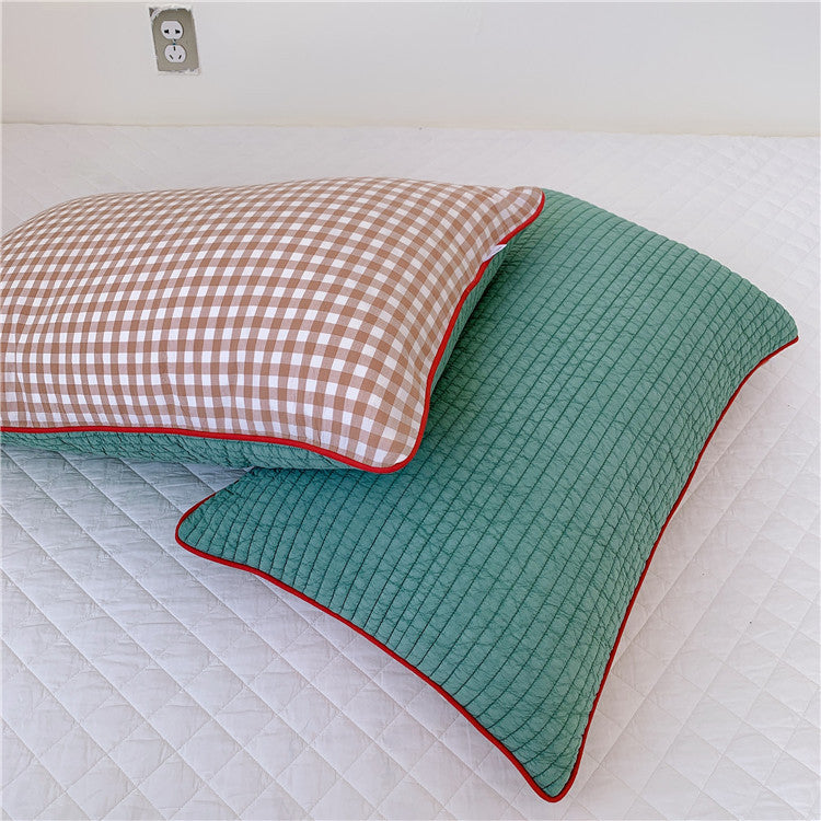 Reversible quilted pillow set with checked cotton cover and contrasting piping