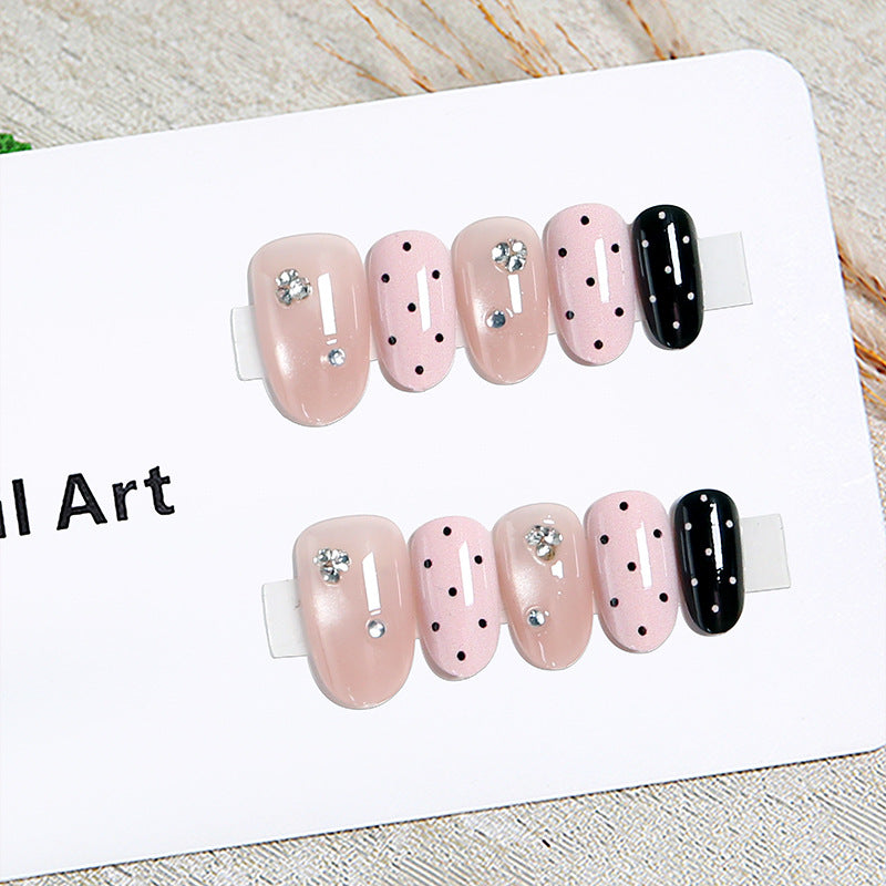 Acrylic nail set with glamorous rhinestone accents and modern dots Stornfield