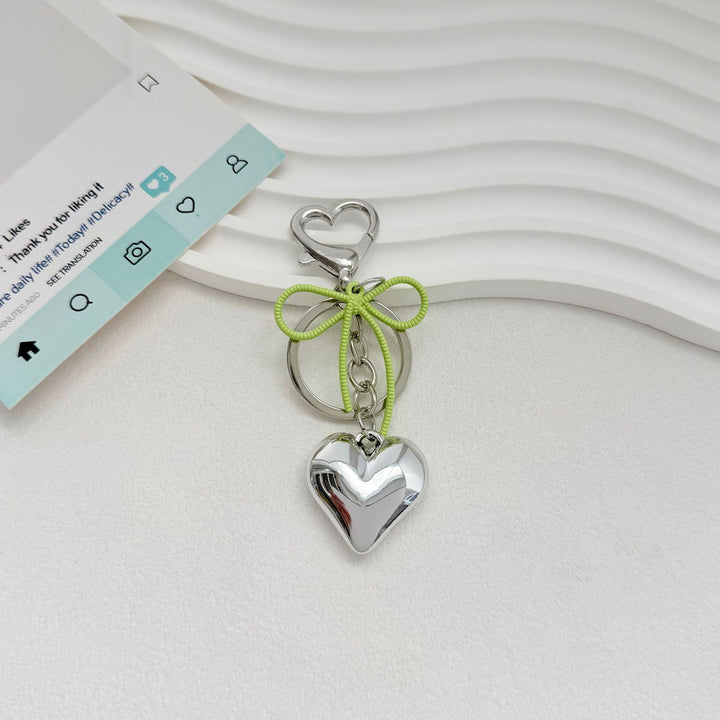 Heart-Shaped Metallic Keychain with Decorative Bow Stornfield