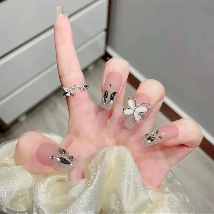 Artful Nail Art with Glitter and Butterfly Elements Stornfield