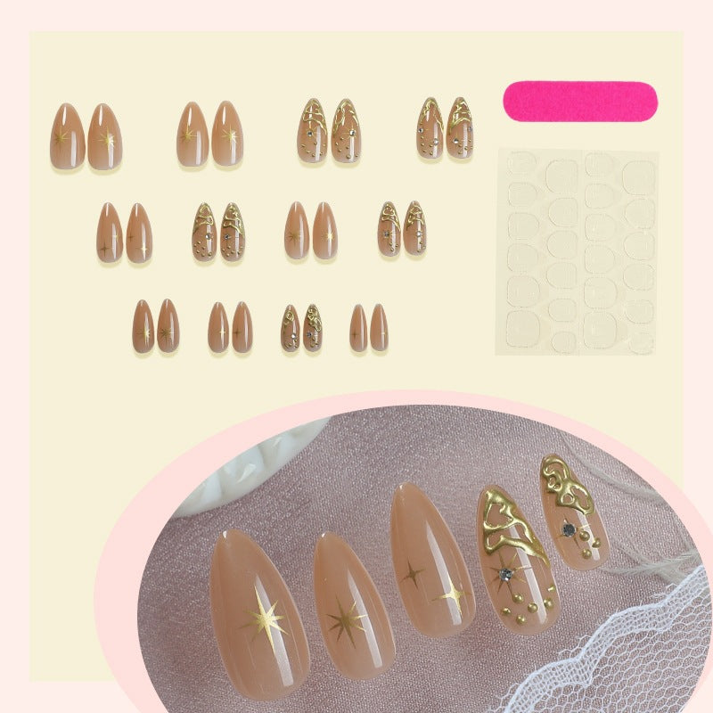Creative nail set with elegant gold embellishments and sparkling accents Stornfield