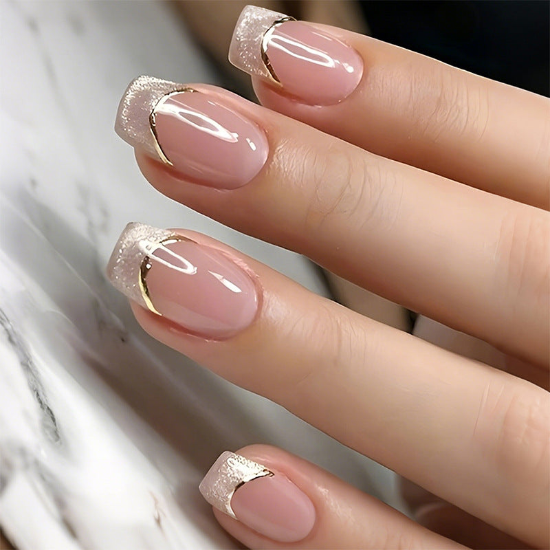 Artificial nail creations with elegant gold trim Stornfield