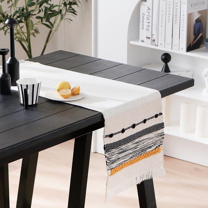 Woven cotton table runner with boho stripes, fringes, and textured woven edge Stornfield