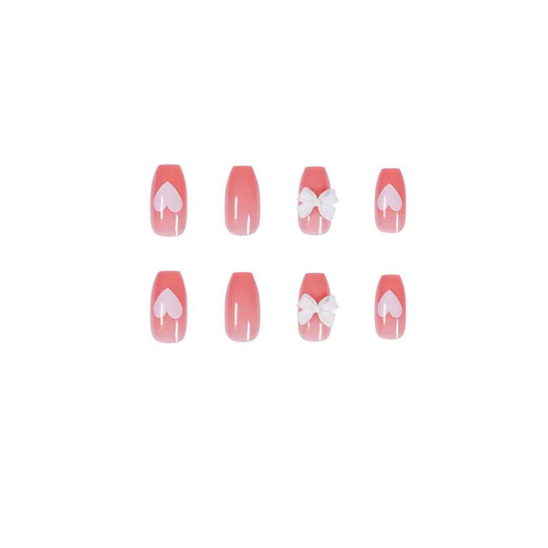 Artistic acrylic nails with heart and bow motifs Stornfield