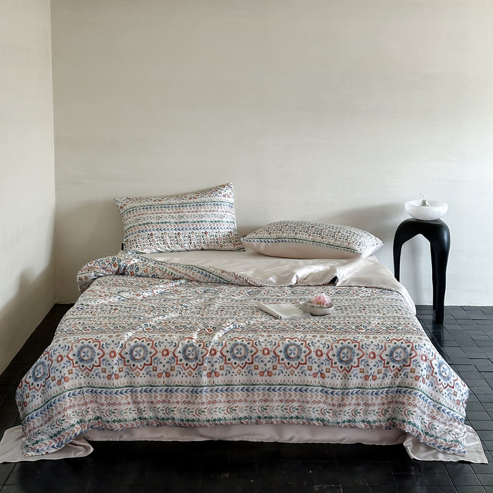 Satin bed linen set with ruffled bed skirt and floral printed pillowcases