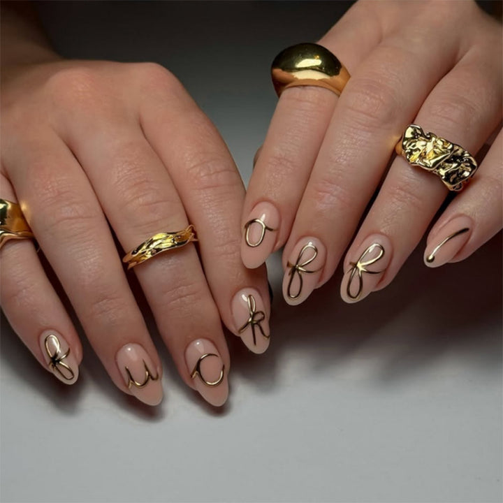 Creative nail art with golden accents and trendy lettering Stornfield