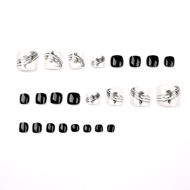 Artful toenail art in elegant black and white design Stornfield