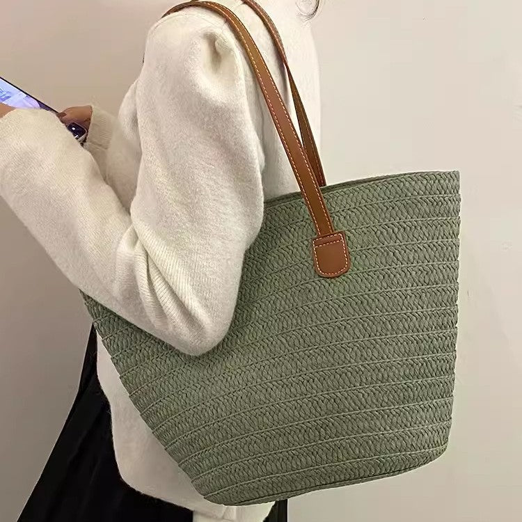 Stylish beach bag made of woven natural material with leather handles Stornfield