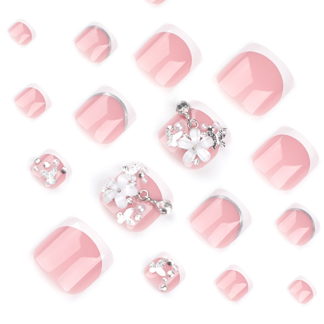 Artful toenail design with elegant flower and glitter accents Stornfield