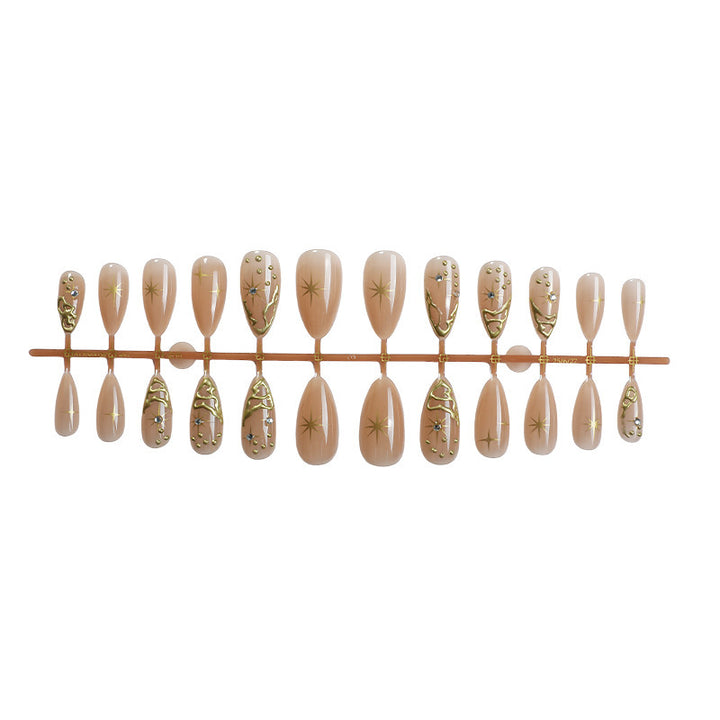 Creative nail set with elegant gold embellishments and sparkling accents Stornfield