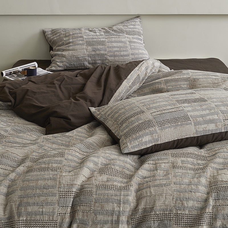 Quilted bed set with textured jacquard stripe design
