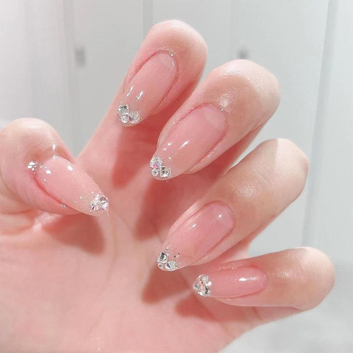 Elegant Nail Art with Glitter and Rhinestone Decorations Stornfield