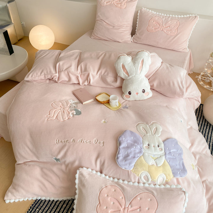 Cozy quilted bedding set with plush appliqué and pompom trim