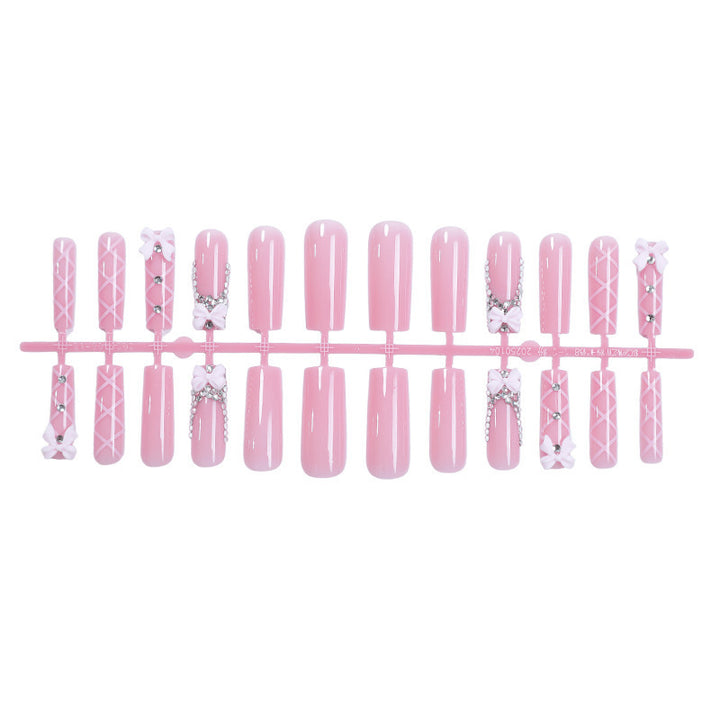 Artificial nail set with romantic bow and glitter accents Stornfield