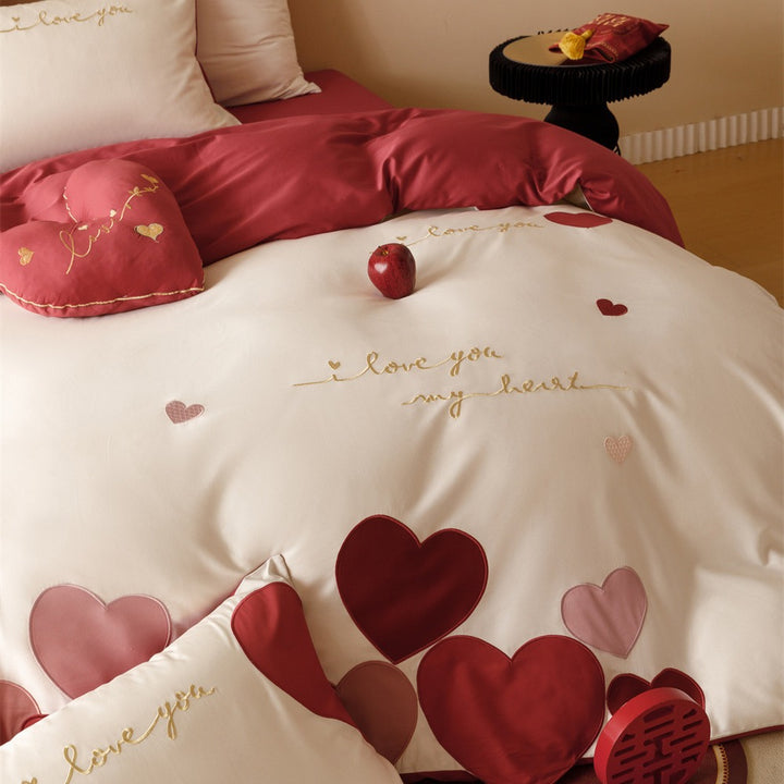 Romantic bedding set made of cotton satin with appliquéd hearts and golden embroidery