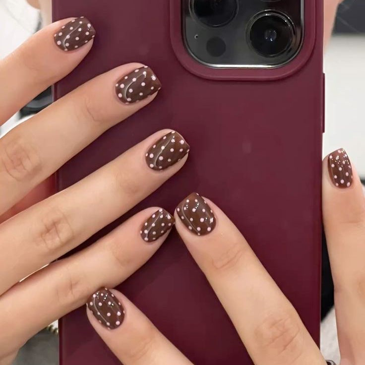 Acrylic nail set with stylish chocolate spots and elegant dots Stornfield