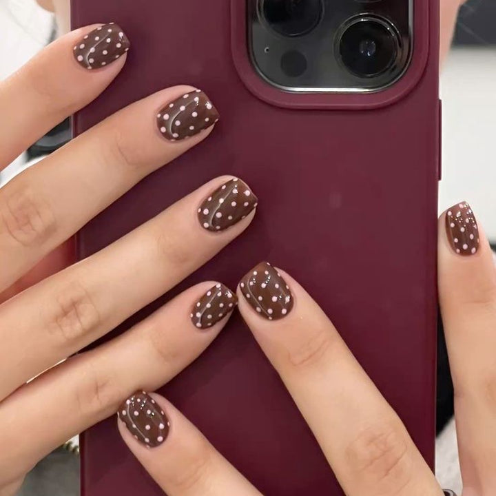 Acrylic nail set with stylish chocolate spots and elegant dots Stornfield