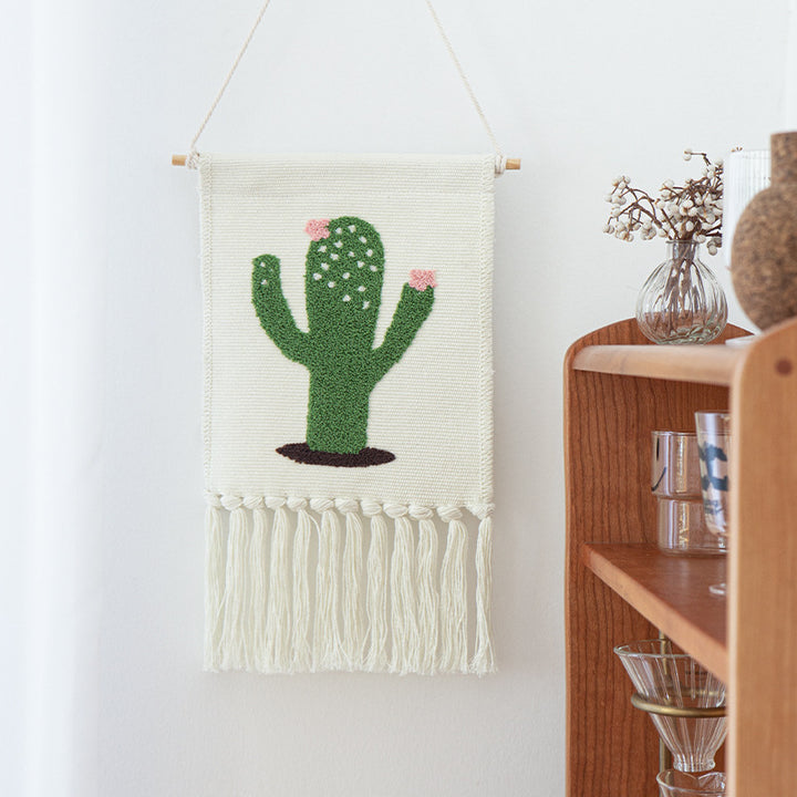 Tufted wall hanging with cactus motif, cotton fringes and wooden stick
