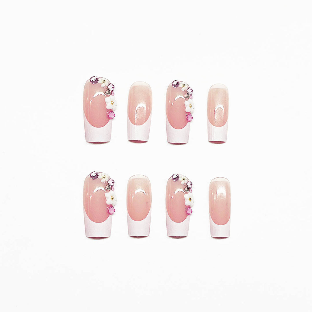 Artificial nail set with elegant floral decorations and transparent finish Stornfield