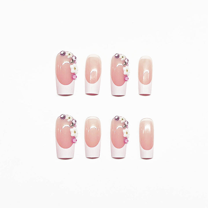 Artificial nail set with elegant floral decorations and transparent finish Stornfield