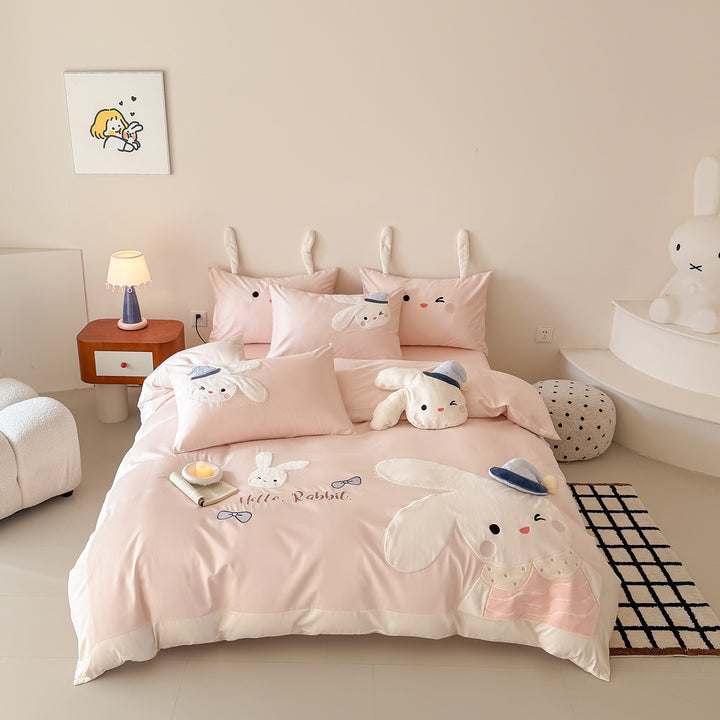 Children's bedding set with three-dimensional ears, plush pillow, and embroidered rabbit appliqués