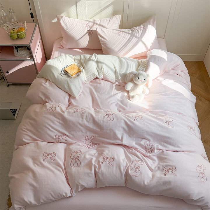Quilted comforter with delicate bird and cloud embroidery
