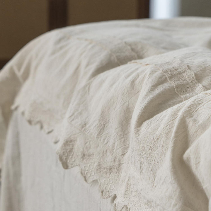 Bed linen set in vintage linen style with lace trim and embroidery detail