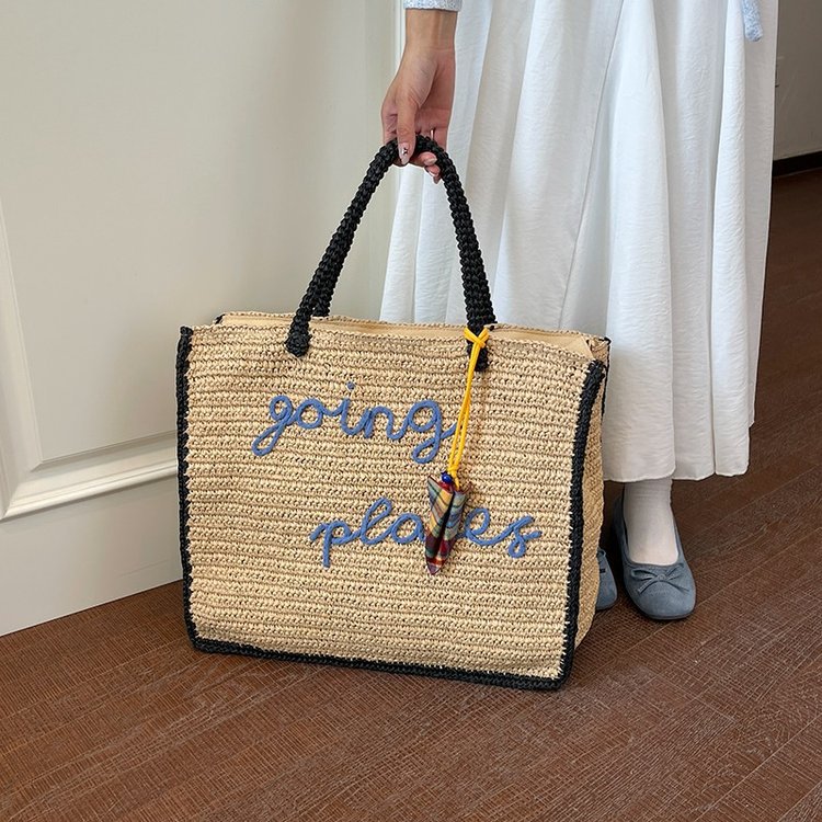 Leisure bag made of woven natural material with colorful pendant Stornfield