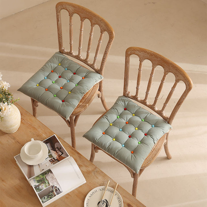 Padded quilted seat cushion with colorful button applications and non-slip underside Stornfield