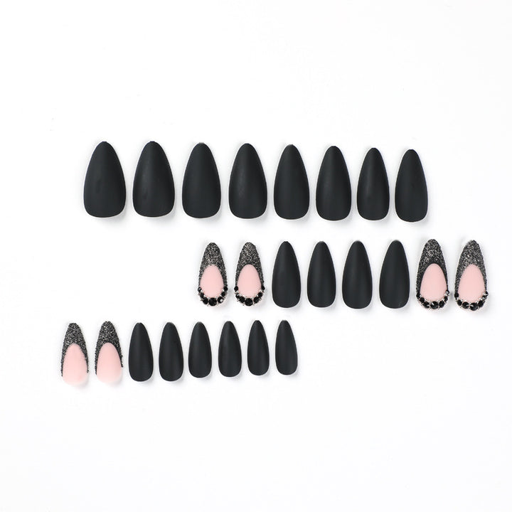 Artful stiletto nails with elegant black design and glitter accents Stornfield