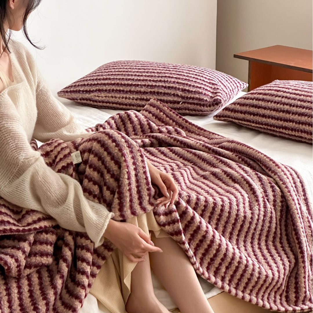 Cozy living blanket with waffle structure and pom-pom cushion set