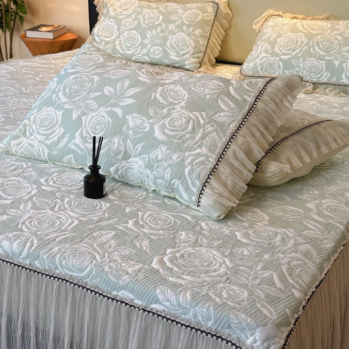 Quilted mattress and pillow set with butterfly motif and pleated bed ruffle