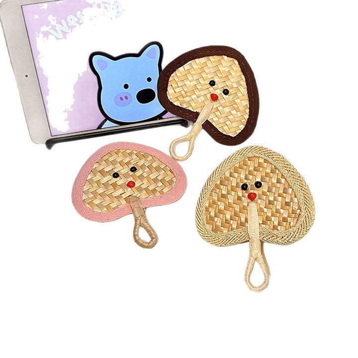 Handcrafted fan with playful face motif Stornfield