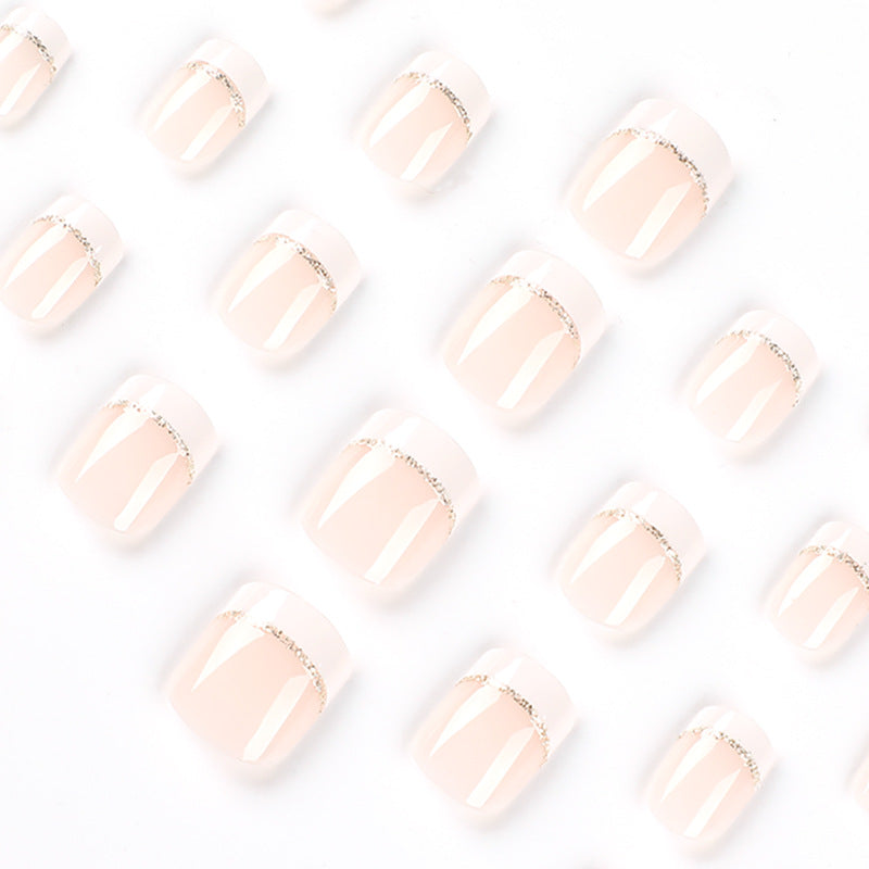 Artful nail extensions with elegant French tip and gold accents Stornfield
