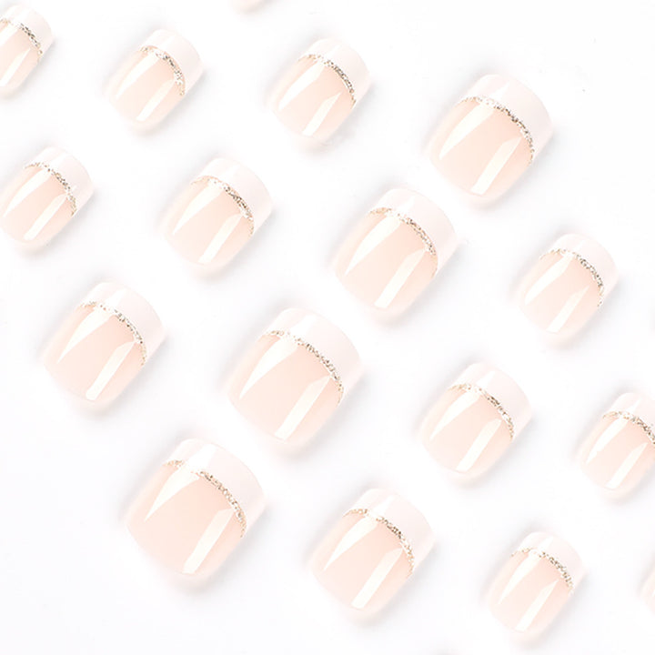 Artful nail extensions with elegant French tip and gold accents Stornfield