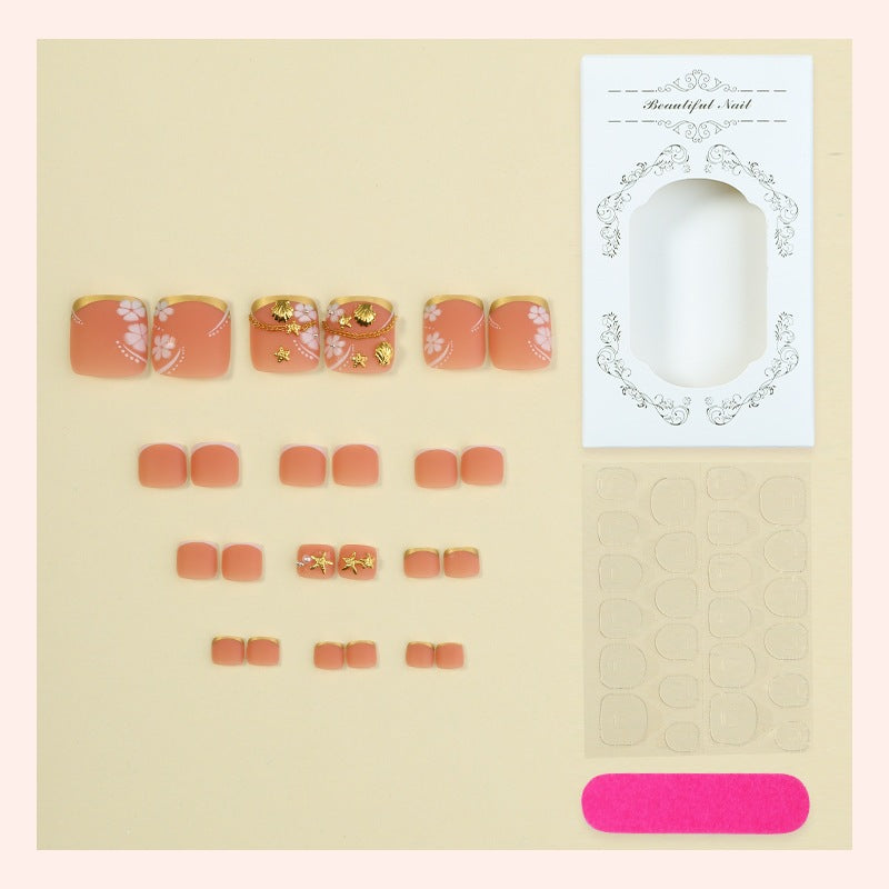 Artificial nail set with elegant, floral accents and golden decorations Stornfield