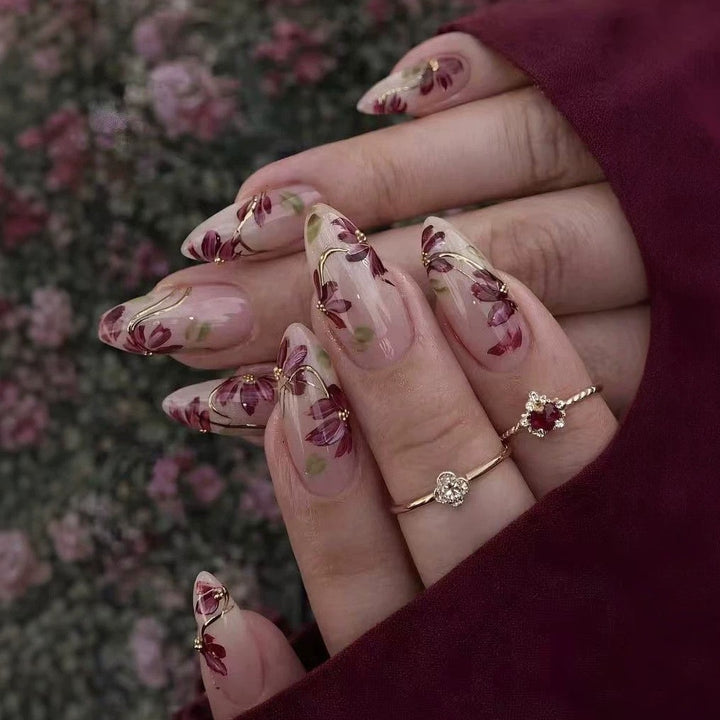 Artificial nail set with floral patterns and golden accents Stornfield