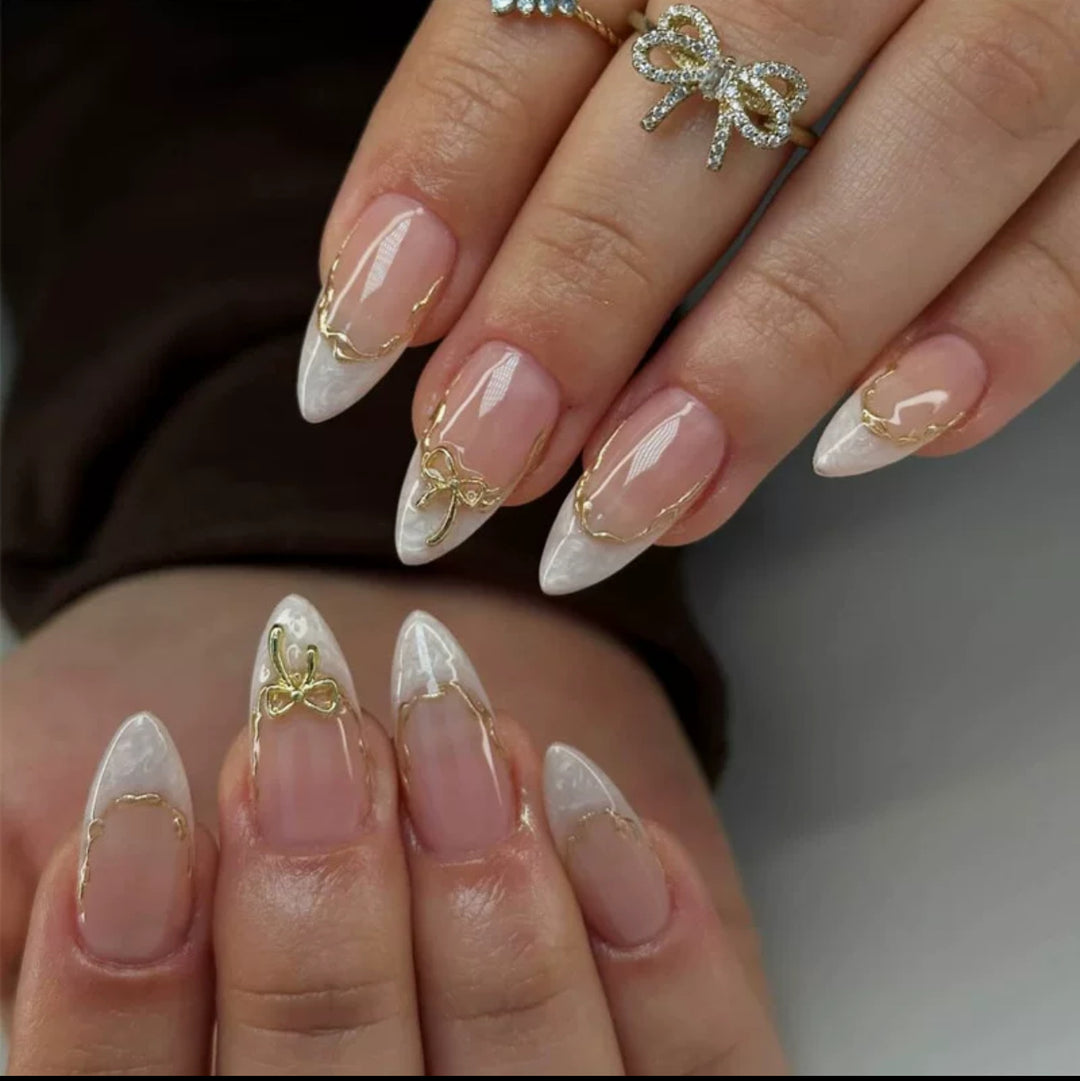 Artificial nails with elegant tip decorations and golden accents Stornfield
