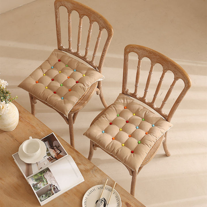 Padded quilted seat cushion with colorful button applications and non-slip underside Stornfield