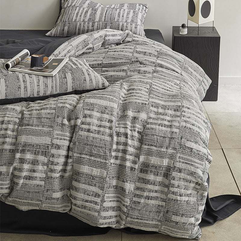 Quilted bed set with textured jacquard stripe design