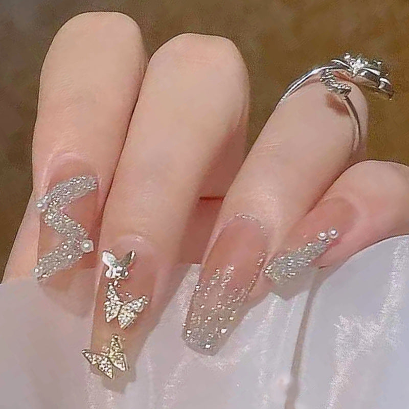 Artificial nails with sparkling rhinestone and bow accents Stornfield