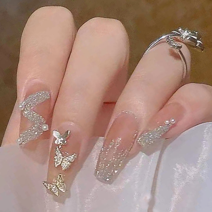 Artificial nails with sparkling rhinestone and bow accents Stornfield