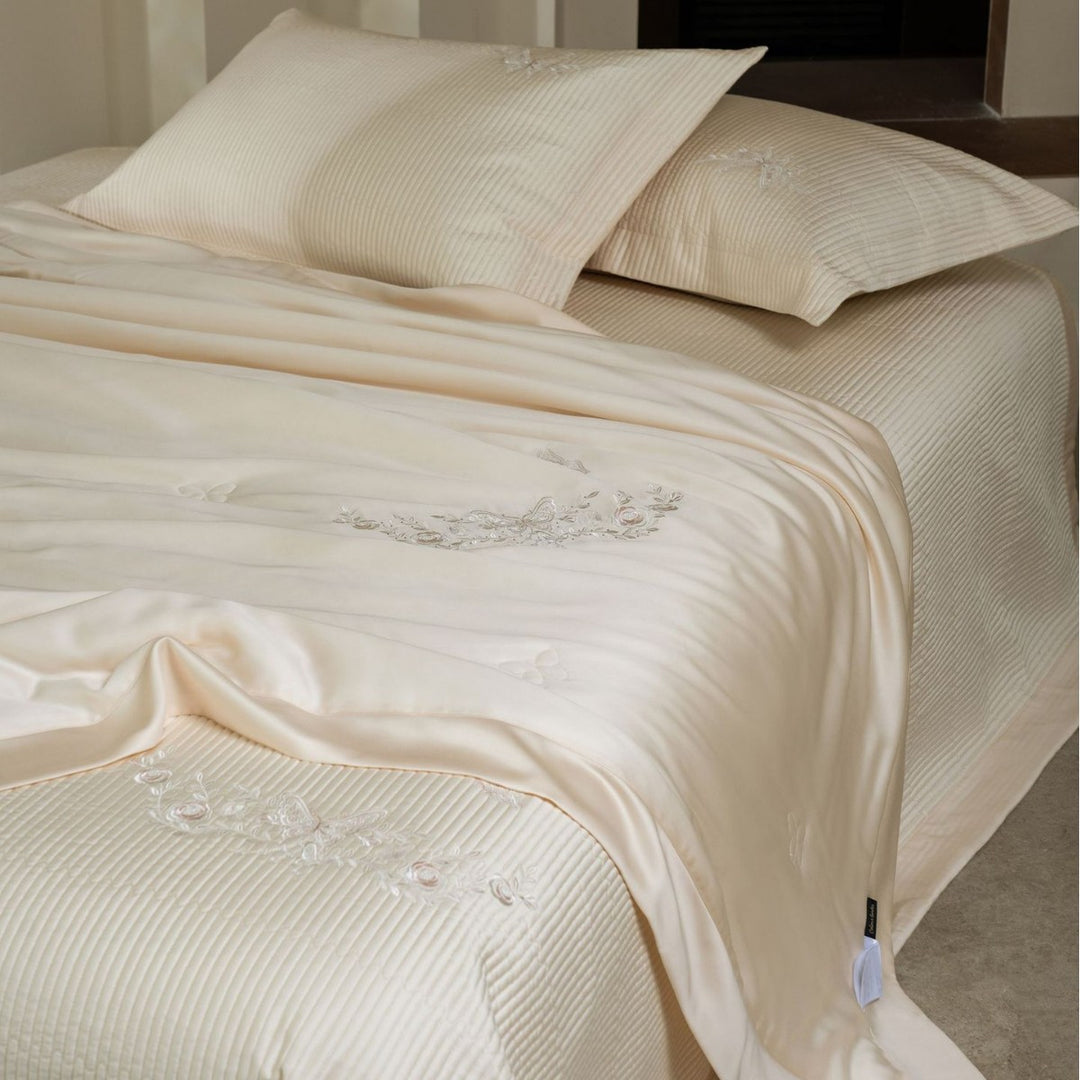 Luxurious cotton satin bedding set with quilted bedspread and floral embroidery
